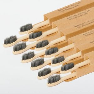 Eco-friendly bamboo toothbrushes in individual cardboard packaging