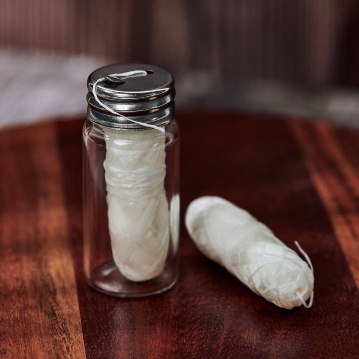 Biodegradable dental floss in glass jar with two eco-friendly refills