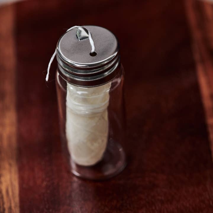 Eco-conscious biodegradable dental floss with glass jar and two refills